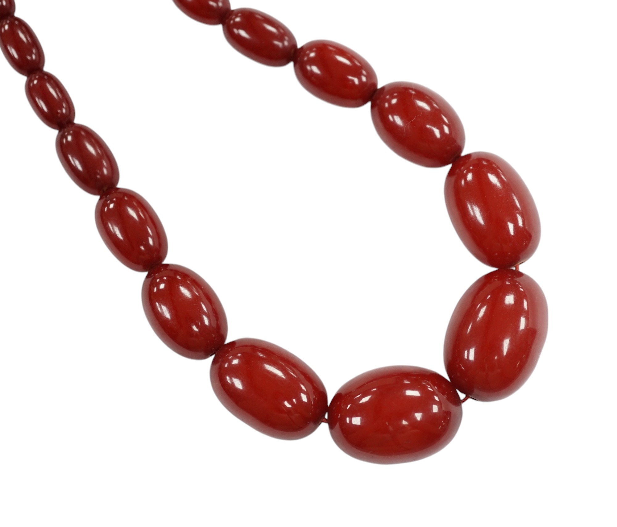 A single strand graduated simulated cherry amber bead necklace, 68cm, gross weight 52 grams. Condition - fair to good